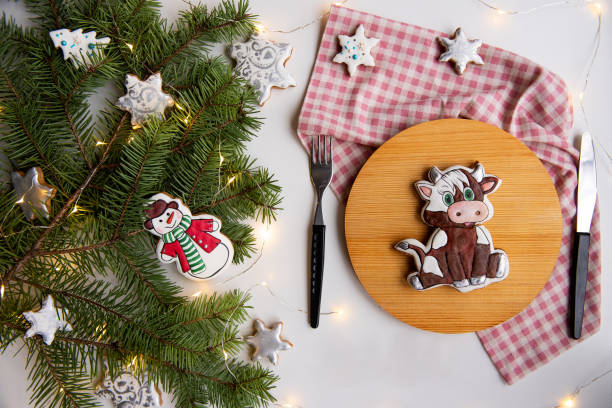 istock Festive Christmas gingerbread Cookies on Table with Pine Branches and Lights 2158875401