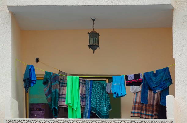 istock Colorful Clothes Hanging On Line Balcony View Beige Background 2158875425