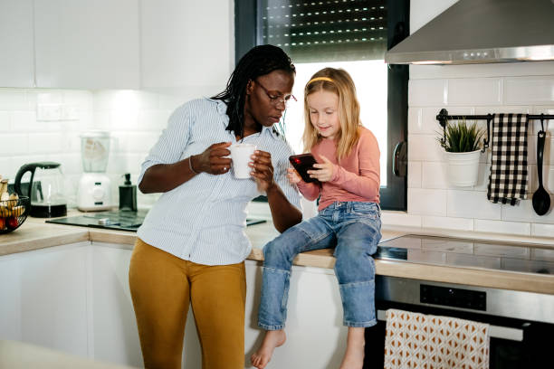 istock Mother and daughter use a mobile phone 2158875713