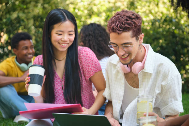 istock A group of students are sitting on a grass studying 2158880142
