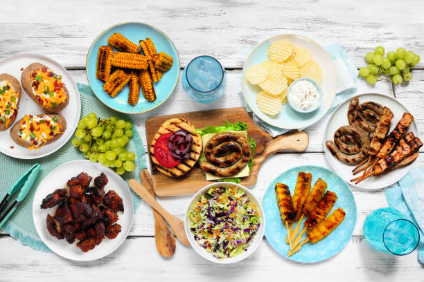 istock Summer BBQ or picnic food table scene, top down view on a white wood background 2158880201