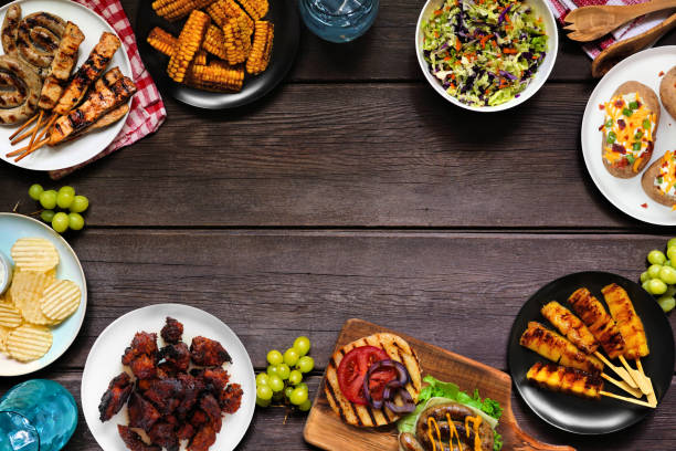 istock Summer BBQ or picnic food frame, top down view on a dark wood background 2158880205