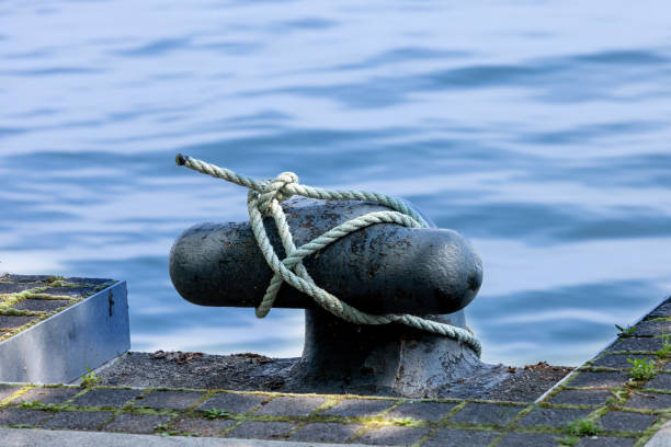 istock A ship bollard on a waterfront pier with a rope tied to it 2158880595