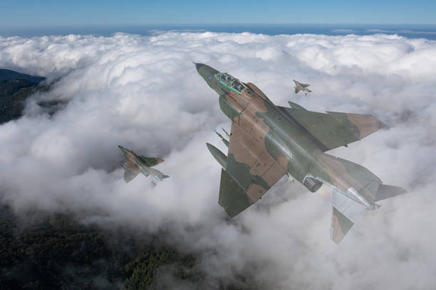 istock Jet aircrafts flying over the clouds. 2158881157