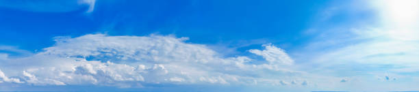 istock blue sky with white cloud background. Clear blue sky and white clouds 2158882880