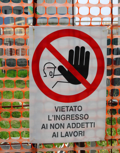 istock Construction site sign with italian text warning unauthorized personnel to stay out behind orange protective netting 2158883527