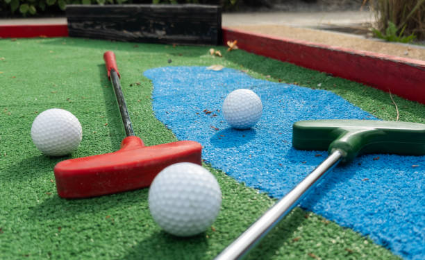 istock colorful golf putters with golf balls on synthetic grass 2158883711
