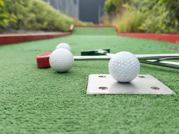 istock colorful golf putters with golf balls on synthetic grass 2158883990