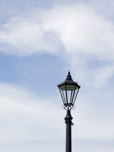 istock Streetlamp on a blue sky background with white clouds 2158886897
