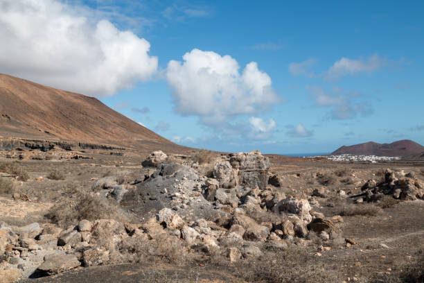 Natural park with various rock formations created by erosion. Called also Stratified City. Blue sky with white clouds in the winter. Teseguite, Lanzarote, Canary Islands, Spain.