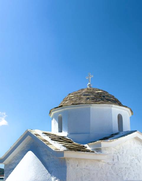 Sifnos Island, Greece, Cyclades Island Chain. July 07, 2025\nThe small Greek Orthodox Monastery of  Efta Martyres in front of the deep blue color of the Aegean Sea.