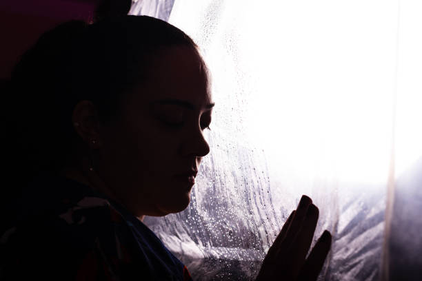 istock Beautiful woman touching her hands on a transparent plastic. 2158898179