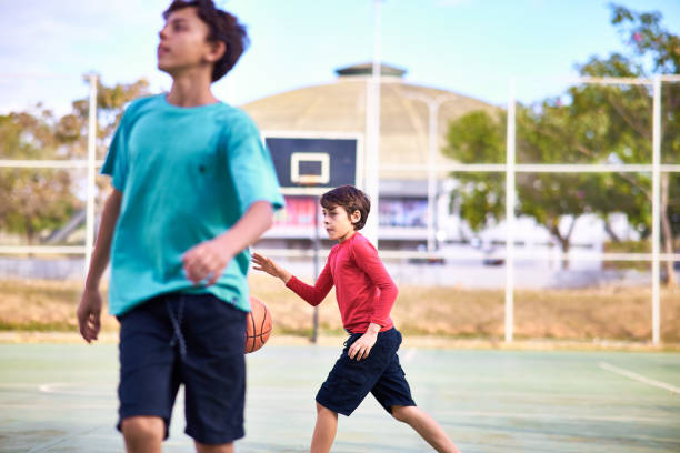 istock Young boys playing Basketball together 2158905086