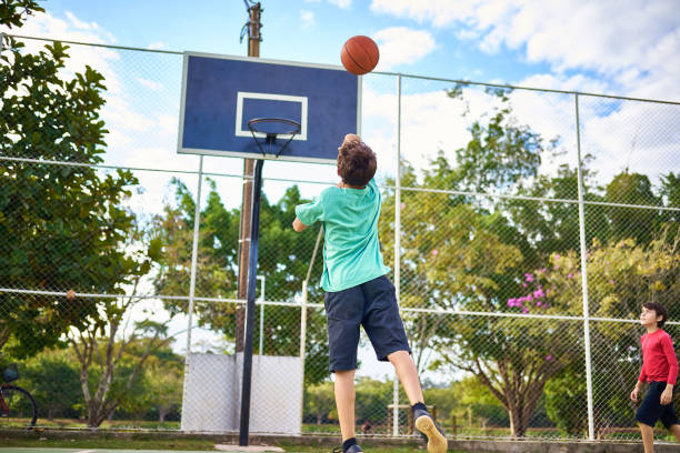 istock Young boys playing Basketball together 2158905112