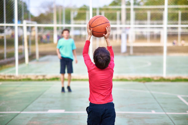 istock Young boys playing Basketball together 2158905121
