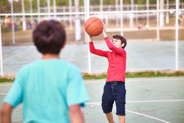 istock Young boys playing Basketball together 2158905122