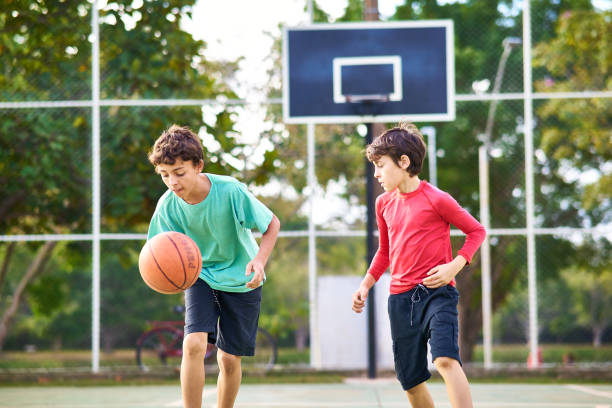 istock Young boys playing Basketball together 2158905133