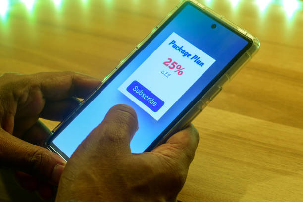 Man looking at his mobile phone displaying a package plan for subscription. Digital newspaper, delivery or streaming service subscription plan concept.