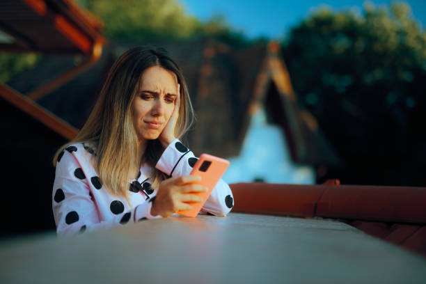 istock Sad Woman Reading a Text Message on her Smartphone 2158913335