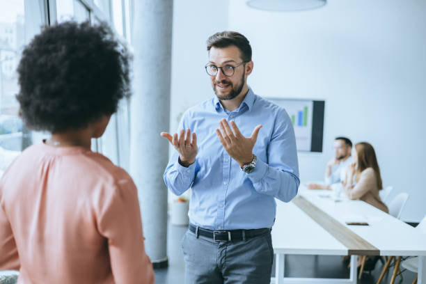 istock Two colleagues talking by side before the meeting 2158914757