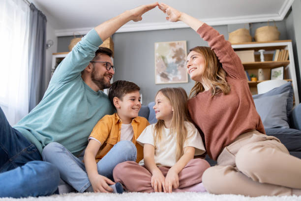 istock Family enjoying quality time forming a house shape 2158914770