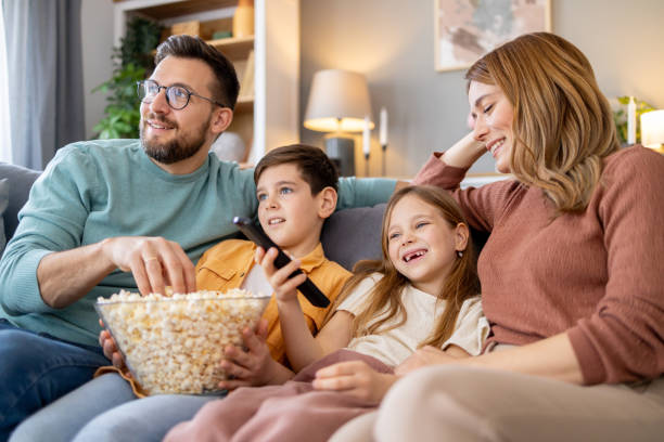 istock Family watching TV and eating popcorn 2158914794
