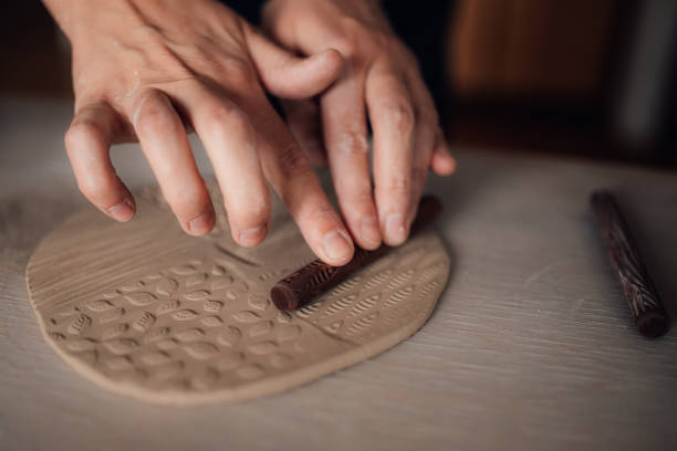 A close up of Japanese made pottery close up held in senior mans hands.