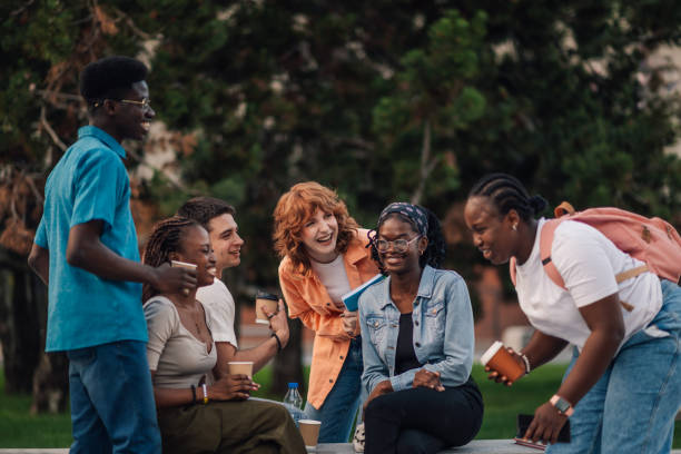 istock Smiling diverse students on a break with coffee having fun at campus. 2158915337