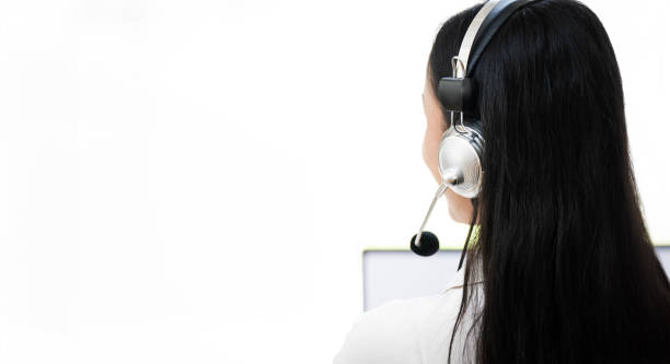 istock Rear view of Young  operator woman agent with headsets working in a call centre. Copy space. 2158918457