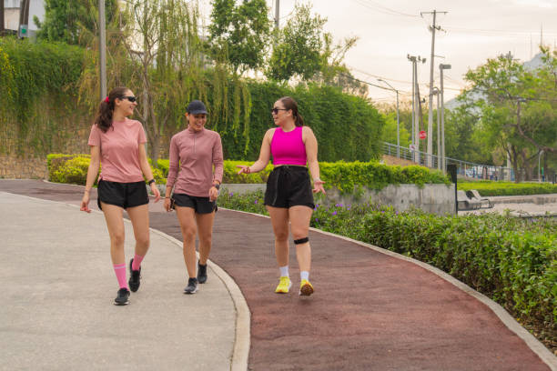 Latin Young Women Walking and Talking in Park Path