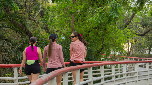 istock Latin Young Women Walking on Bridge in Park 2158922880