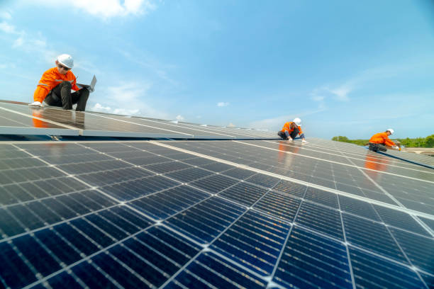 istock engineer man inspects construction of solar cell panel or photovoltaic cell by electronic device. Industrial Renewable energy of green power. factory worker working on tower roof. 2158922882