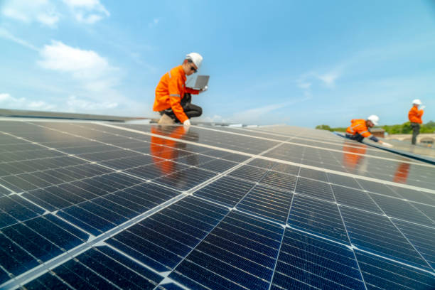 istock engineer man inspects construction of solar cell panel or photovoltaic cell by electronic device. Industrial Renewable energy of green power. factory worker working on tower roof. 2158923020
