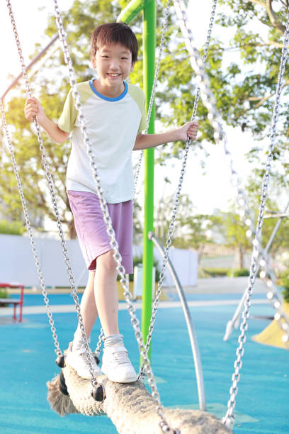 Young boy balancing on beam at play park