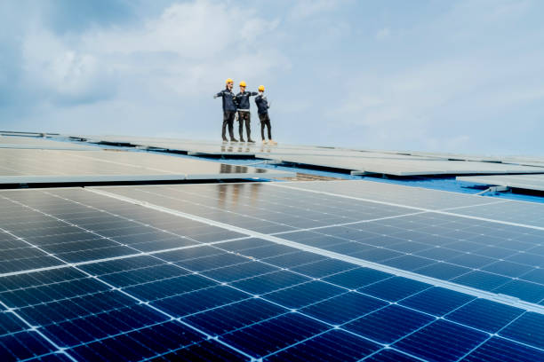 istock engineer man inspects construction of solar cell panel or photovoltaic cell by electronic device. Industrial Renewable energy of green power. factory worker working on tower roof. 2158923295
