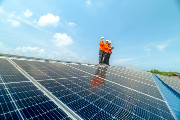 istock engineer man inspects construction of solar cell panel or photovoltaic cell by electronic device. Industrial Renewable energy of green power. factory worker working on tower roof. 2158923954