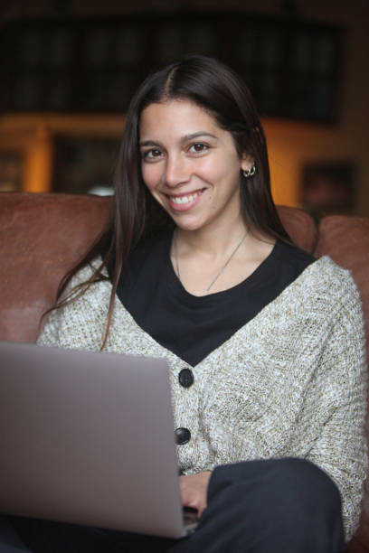 istock young cheerful  woman using laptop indoors 2158923983