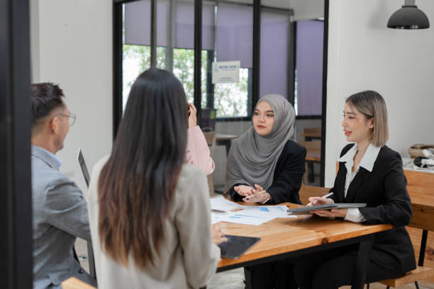 istock Asian Business Group Chat about graph work Present in meetings, in the office 2158926054