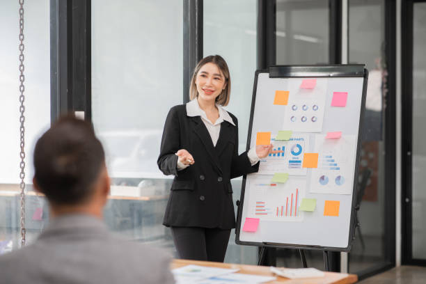 istock Asian Business Group Chat about graph work Present in meetings, in the office 2158926092