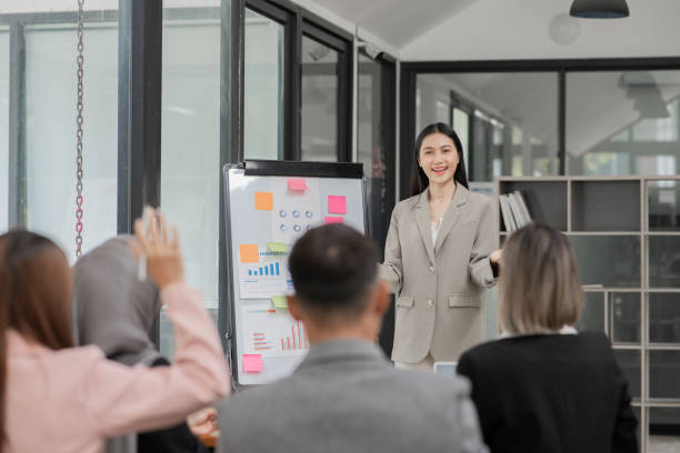 istock Asian Business Group Chat about graph work Present in meetings, in the office 2158926161