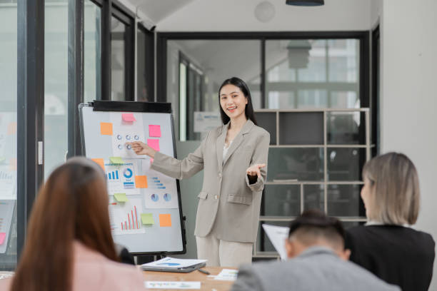 istock Asian Business Group Chat about graph work Present in meetings, in the office 2158926174