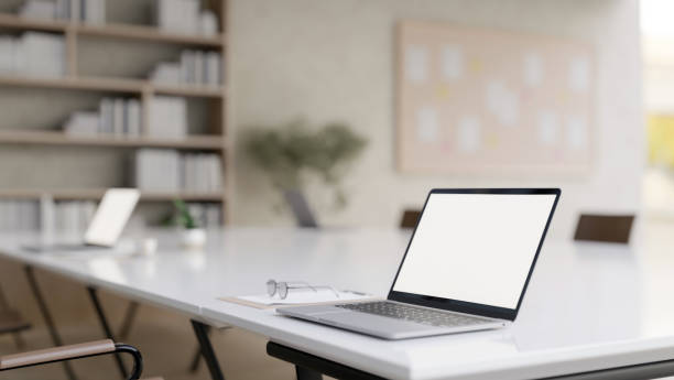 istock A laptop computer on a meeting table in a contemporary meeting room or office co-working space. 2158926335