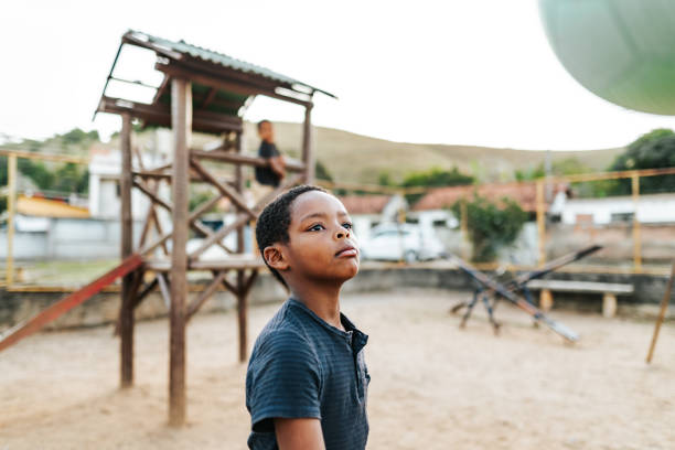 istock Boy playing with a ball on the playground 2158927156