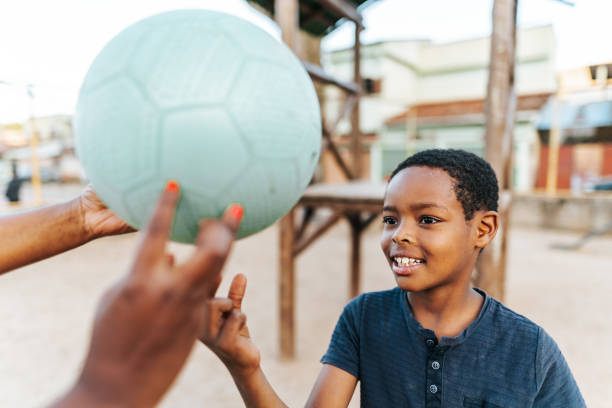 Boy playing with a ball on the playground
