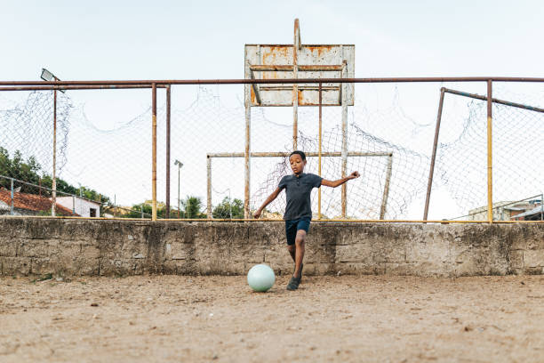istock Boy playing soccer on the playground 2158927190
