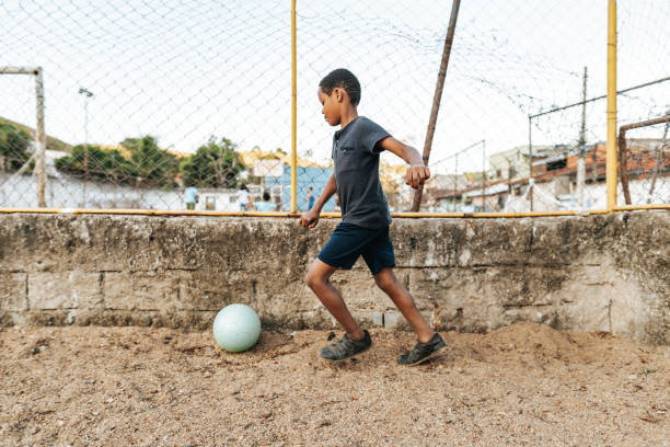 istock Boy playing soccer on the playground 2158927203