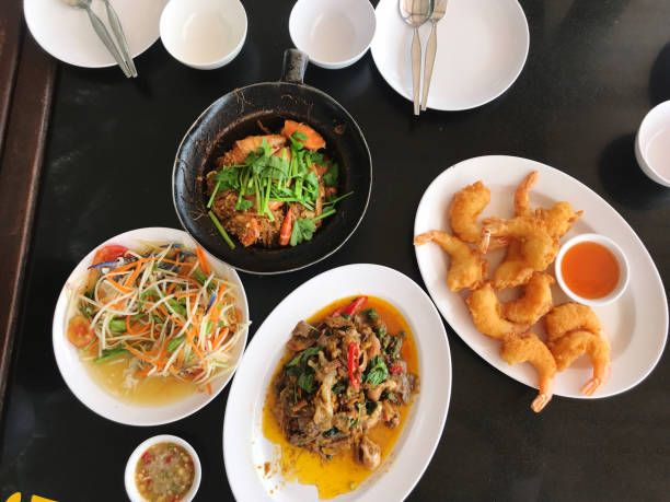 istock Fried noodle with pork and shrimp in black bowl on table 2158928200
