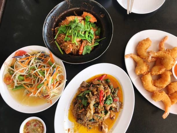 istock Fried noodle with pork and shrimp in black bowl on table 2158928266