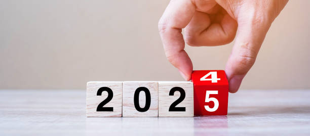istock hand flipping block 2024 to 2025 text on table. Resolution, strategy, plan, goal, motivation, reboot, business and New Year holiday concepts 2158932581