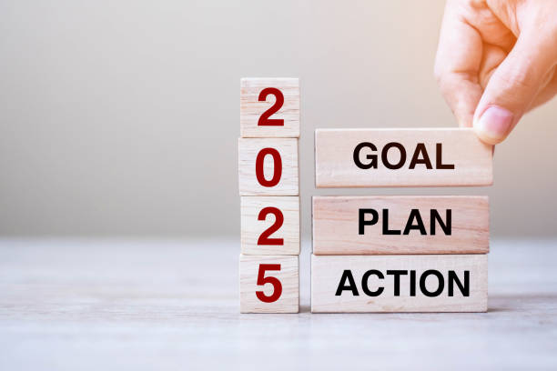 istock hand holding wooden block with text 2025 GOAL, PLAN and ACTION on table background. Resolution, strategy, solution, goal, business and New Year holiday concepts 2158932588